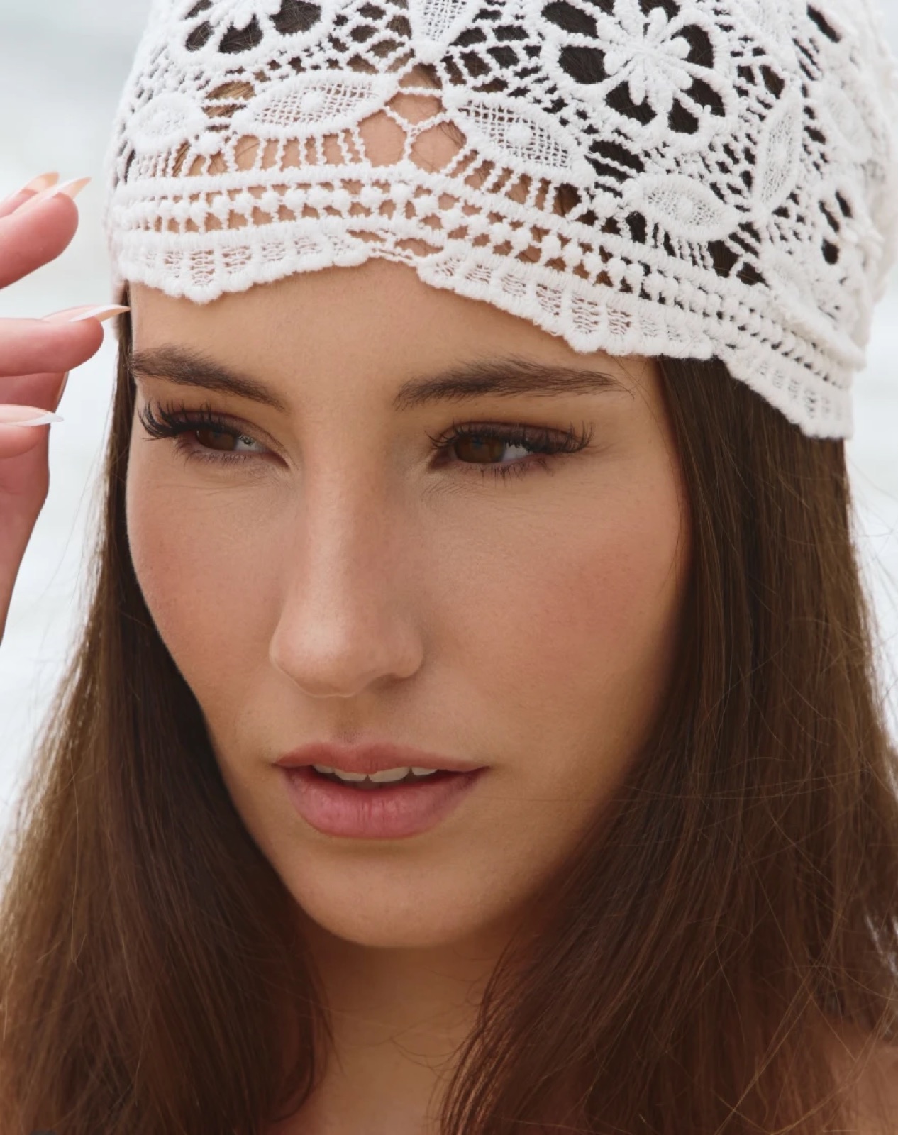 Soft editorial makeup with a lace headpiece