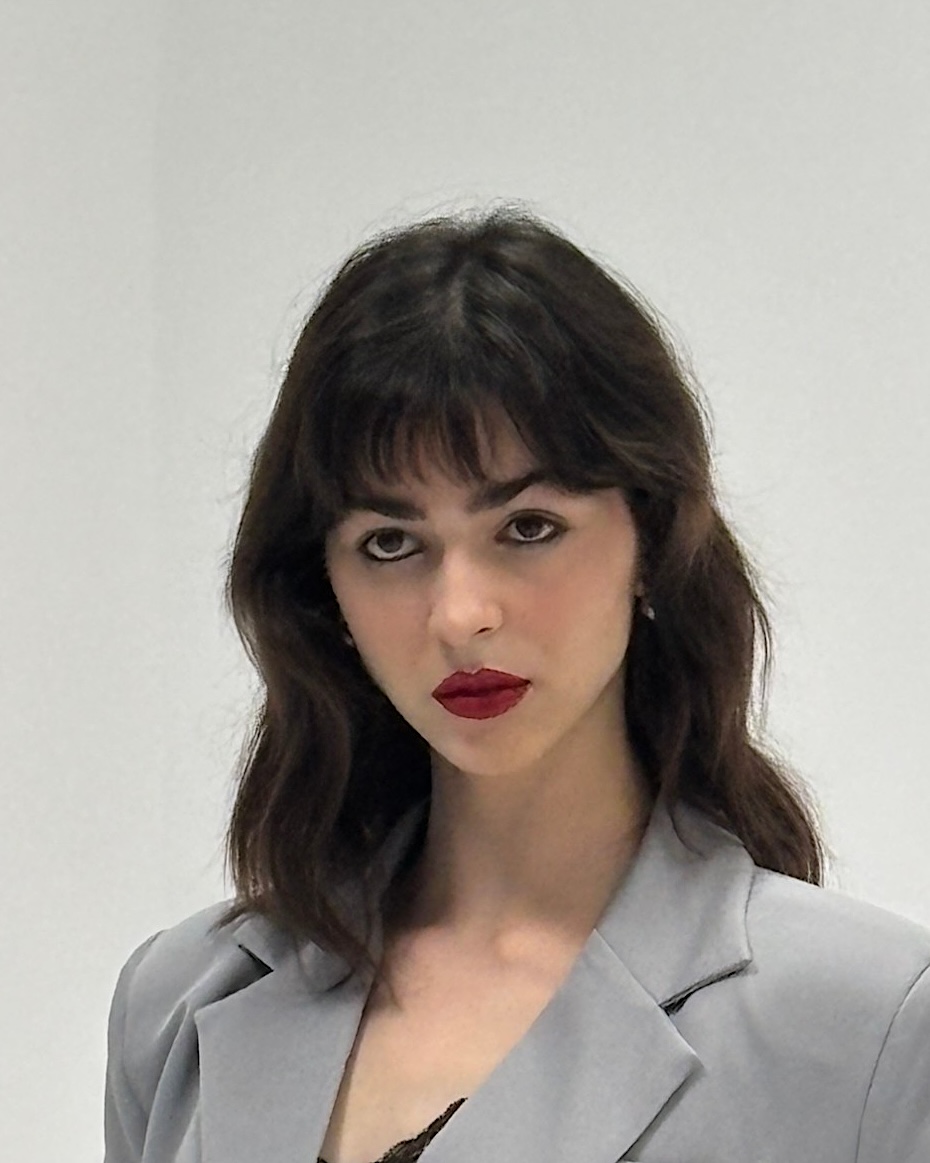 Editorial look with a deep red lip, smudged liner and a fringe