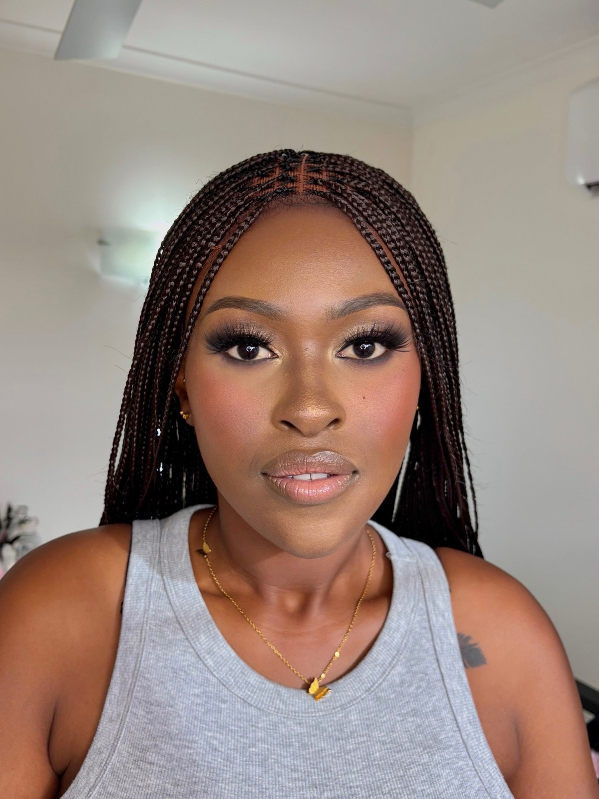 Bronzed soft glam with a smoky eye and glossy nude lip